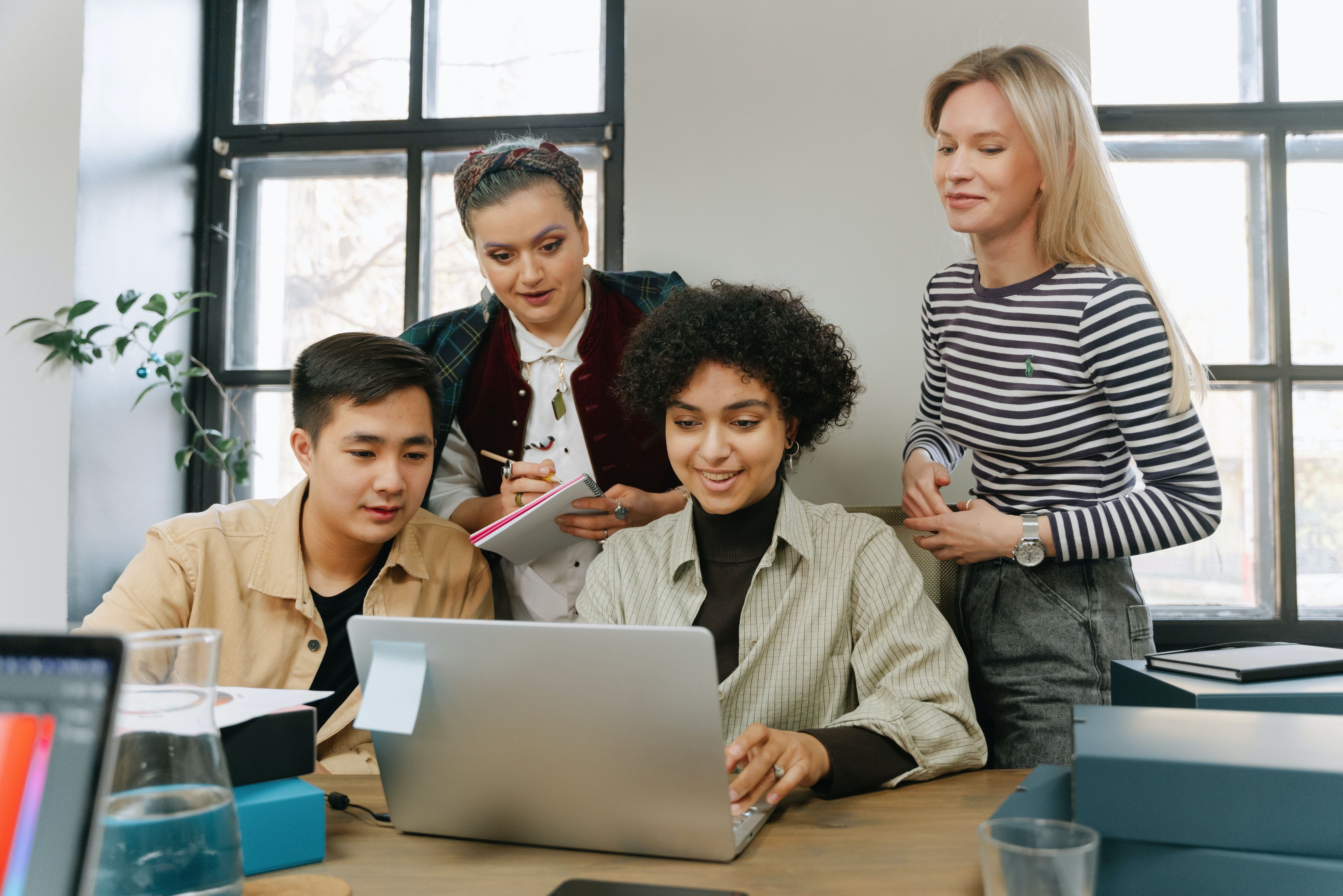 Group of people looking at laptop